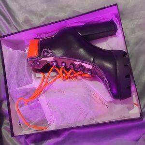 Heeled black camo boots with orange laces